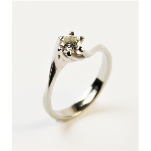 180 - A diamond solitaire ring, comprising a central round brilliant cut diamond weighing an estimated 0.2... 