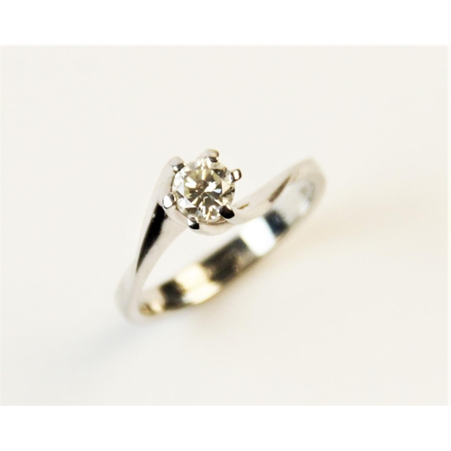 180 - A diamond solitaire ring, comprising a central round brilliant cut diamond weighing an estimated 0.2... 