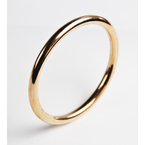 224 - A 9ct gold tubular slave bangle by S Ward & Sons, Chester 1920, 9cm diameter, weight 16.7gms