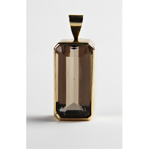 230 - A 9ct smoky quartz pendant, the central rectangular emerald cut quartz measuring 30mm x 15mm, set to... 