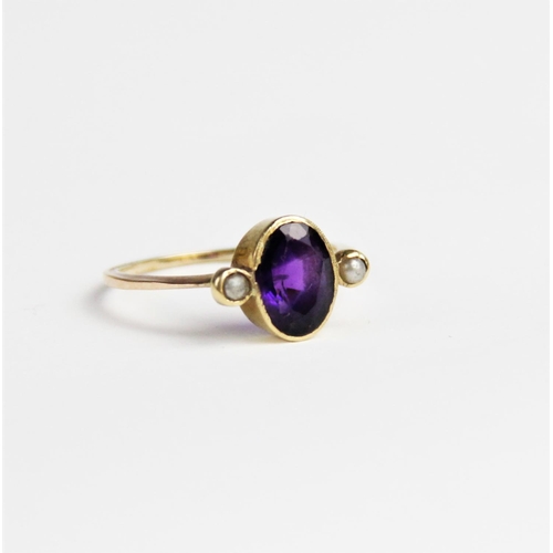 239 - An amethyst and pearl dress ring, comprising a central oval mixed cut amethyst measuring 9mm x 6mm, ... 