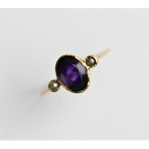 239 - An amethyst and pearl dress ring, comprising a central oval mixed cut amethyst measuring 9mm x 6mm, ... 