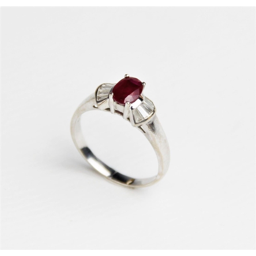 240 - A ruby and diamond 18ct gold ring, comprising a central oval mixed cut ruby measuring approx. 7mm x ... 