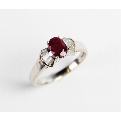 240 - A ruby and diamond 18ct gold ring, comprising a central oval mixed cut ruby measuring approx. 7mm x ... 