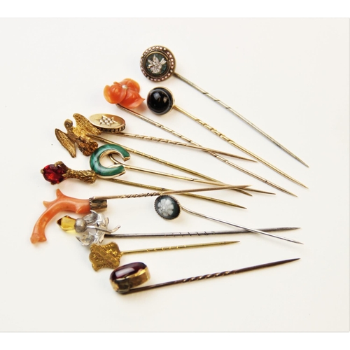 250 - An assortment of Victorian and later stick pins, to include a coral set example, 8cm long, a horsesh... 