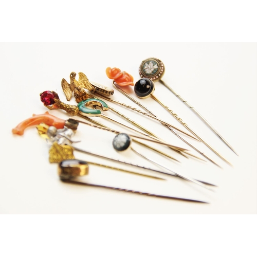 250 - An assortment of Victorian and later stick pins, to include a coral set example, 8cm long, a horsesh... 