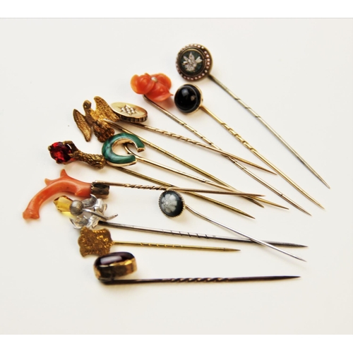 250 - An assortment of Victorian and later stick pins, to include a coral set example, 8cm long, a horsesh... 