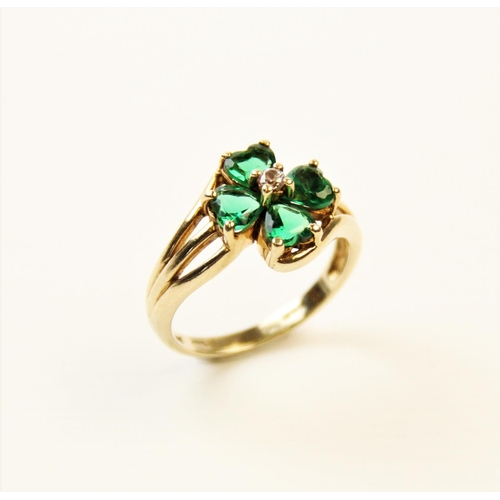 253 - A paste set 9ct gold four-leaf clover ring, the central cluster comprising four heart-shaped green p... 