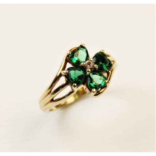 253 - A paste set 9ct gold four-leaf clover ring, the central cluster comprising four heart-shaped green p... 