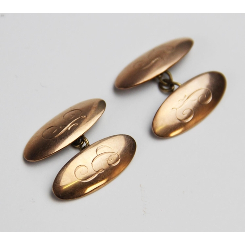 258 - A pair of 9ct gold cufflinks, each of of oval form with engraved initials 'F' and 'G', each panel 24... 