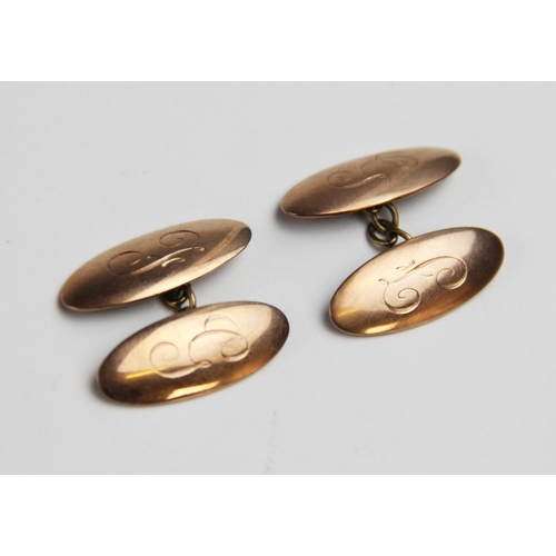 258 - A pair of 9ct gold cufflinks, each of of oval form with engraved initials 'F' and 'G', each panel 24... 