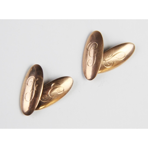 258 - A pair of 9ct gold cufflinks, each of of oval form with engraved initials 'F' and 'G', each panel 24... 