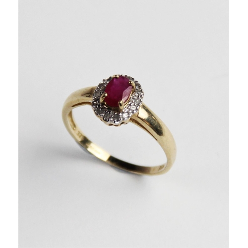 283 - A ruby and diamond 9ct cluster ring, comprising a central oval mixed cut ruby measuring 6mm x 4mm, w... 