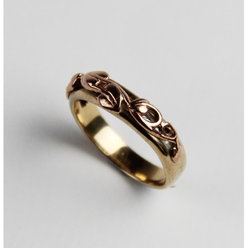 284 - A two-colour 9ct Clogau gold ring, the plain polished yellow gold band with applied 9ct rose gold sc... 