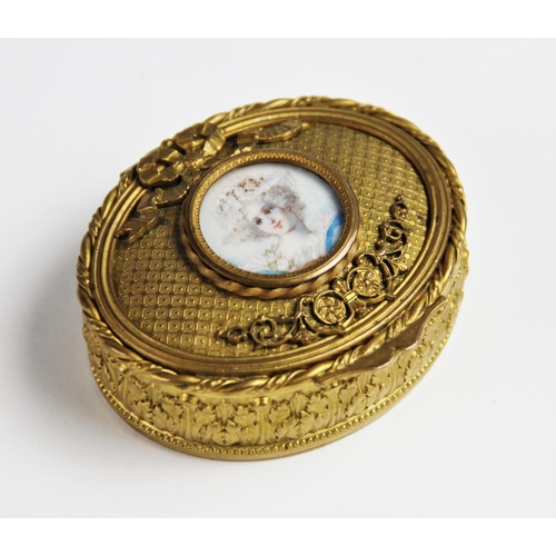 300 - A French gilt metal box, 19th century, the box of oval form with relief moulded scrolling acanthus l... 