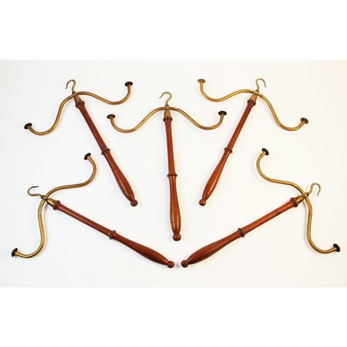 318 - Five Victorian wig and gown hangers, the lacquered brass hooks terminating two arms supported by a t... 