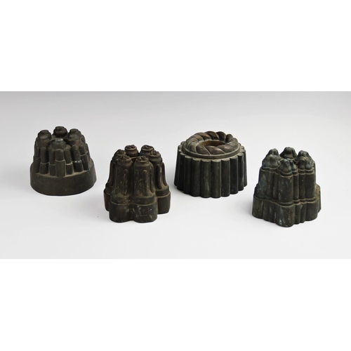 319 - Four 19th century copper estate jelly moulds, each of varying form to include three castellated exam... 