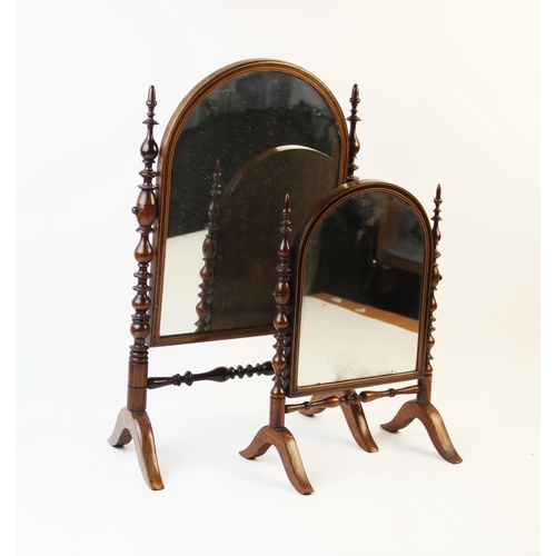 338 - A graduated pair of 19th century Puginesque dressing table mirrors, the turned walnut supports termi... 