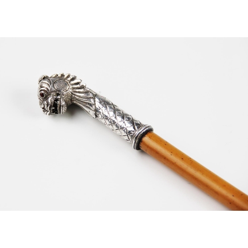 34 - A Indian silver mounted Malacca swagger stick, 19th century, the tapered cane mounted with a lions m... 