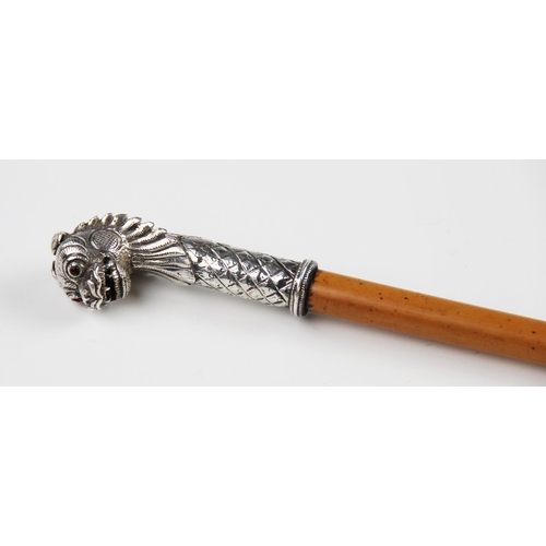 34 - A Indian silver mounted Malacca swagger stick, 19th century, the tapered cane mounted with a lions m... 