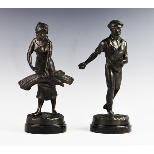 347 - Two cast spelter figures, 20th century, one modelled as a man sowing seed, the other as a woman bind... 