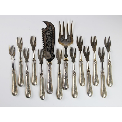 40 - A set of twelve continental silver handled fish forks, each weighted handle with engraved detailing ... 