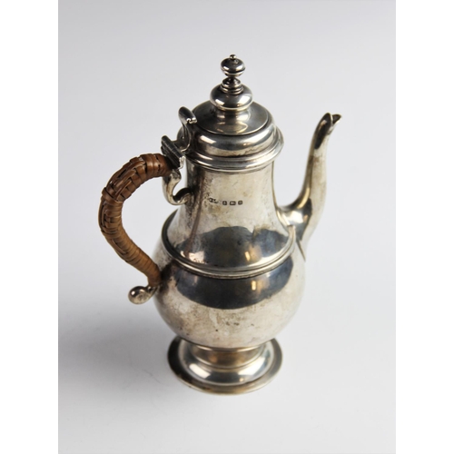 43 - A George V silver coffee pot by Wilson & Sharp, Birmingham 1912, of baluster form on domed circular ... 