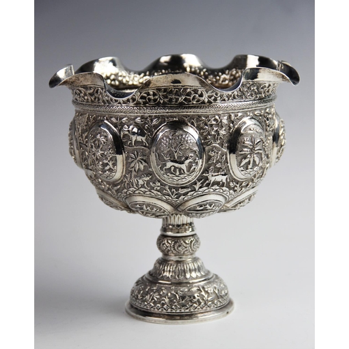48 - An Indian silver pedestal bowl, with shaped rim on knopped stem and domed foot, with elaborate repou... 
