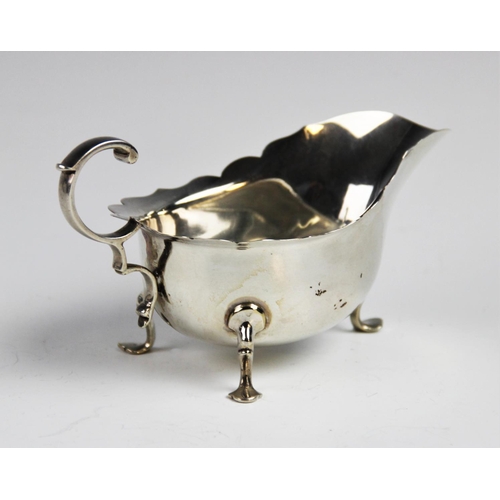 54 - A George V silver sauce boat and ladle by Martin Hall & Co Ltd, Sheffield 1918, the sauce boat with ... 
