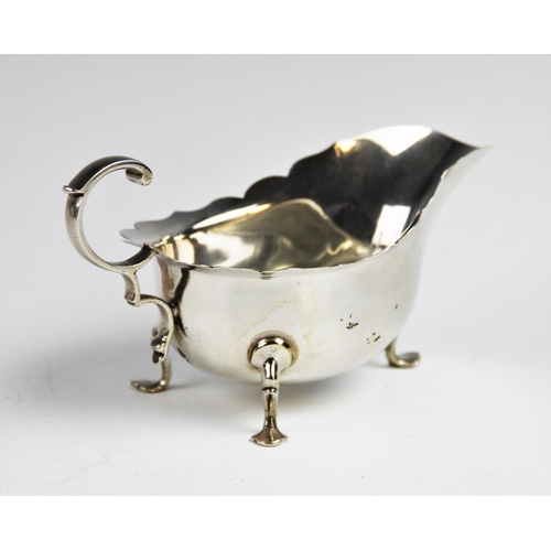54 - A George V silver sauce boat and ladle by Martin Hall & Co Ltd, Sheffield 1918, the sauce boat with ... 