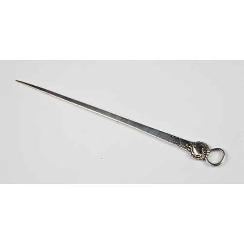 63 - A George III silver meat skewer, London 1775, of typical form with ring loop and scrolling foliate d... 