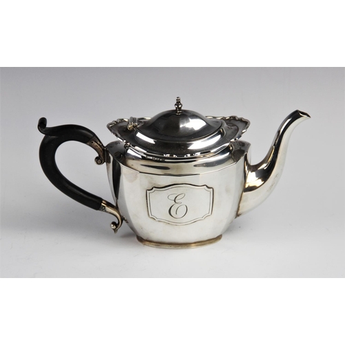 74 - A George V silver teapot by Walker & Hall, Birmingham 1926, of oval faceted form with shaped rim and... 