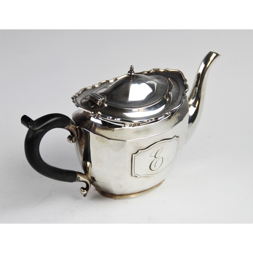 74 - A George V silver teapot by Walker & Hall, Birmingham 1926, of oval faceted form with shaped rim and... 