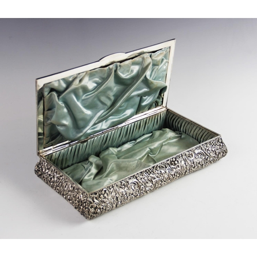 8 - An Edwardian silver mounted box by Henry Matthews, Birmingham 1903, of rectangular form with elabora... 