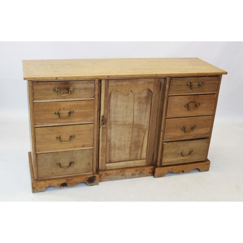 821 - A Victorian pine kitchen dresser base, the rectangular top with a later galleried back, above three ... 