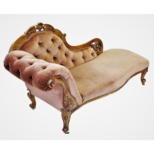 829 - A Victorian walnut framed chaise longue, the shaped back with a carved crest extending to a leaf car... 