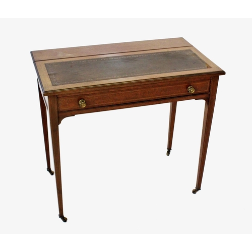 849 - An Edwardian mahogany lady's writing table, the rear hinged panel enclosing a stationery compartment... 