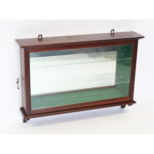 854 - An early 20th century mahogany wall display cabinet, with a single lockable door enclosing a mirrore... 