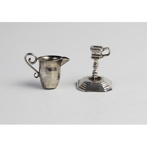 88 - A Dutch silver novelty miniature candlestick, of faceted form with knopped stem on stepped octagonal... 