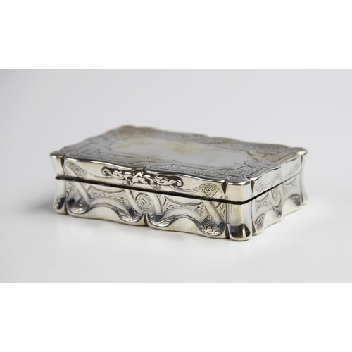 94 - A large Victorian silver snuff box by Edward Smith, Birmingham 1858, of rectangular form with shaped... 