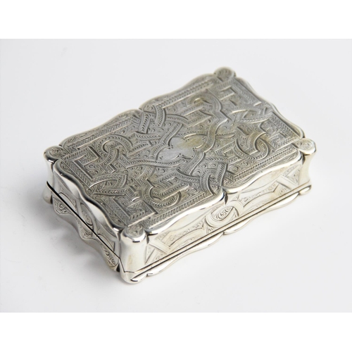 94 - A large Victorian silver snuff box by Edward Smith, Birmingham 1858, of rectangular form with shaped... 