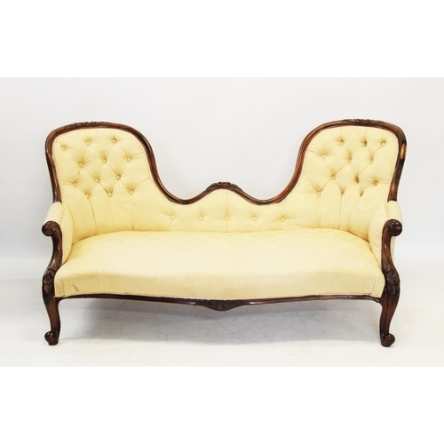 827 - A Victorian rosewood framed double ended chaise longue, the twin arched button back above a serpenti... 