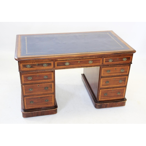 858 - An Edwardian mahogany and satinwood crossbanded twin pedestal desk, the rectangular moulded top with... 