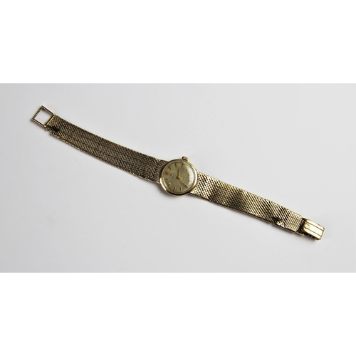 134 - A lady's vintage 9ct gold Omega wristwatch, the circular silver dial with baton markers set to a pla... 