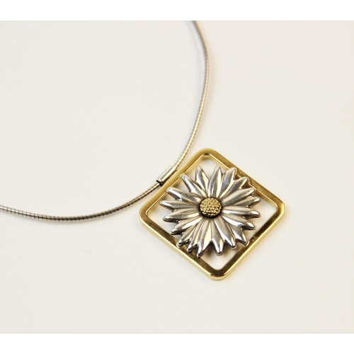 251 - A Tiffany 18ct gold and silver daisy pendant, designed as a two-colour moulded daisy set to a square... 