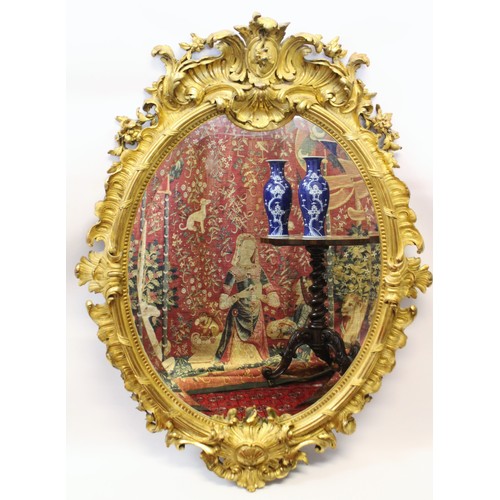 819 - A 19th century Rococo style gilt wood and gesso oval wall mirror, the foliate swept frame with a mou... 