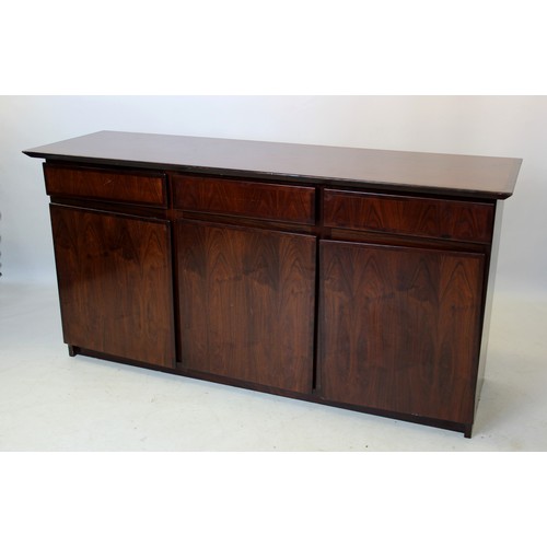 841 - A mid 20th century Danish design rosewood sideboard by Dyrlund, the rectangular top above three cros... 