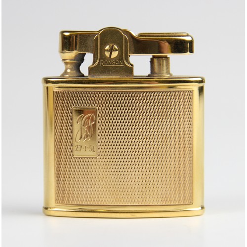 294 - A gold plated Ronson lighter, of rectangular form with engine turned decoration with cartouche engra... 