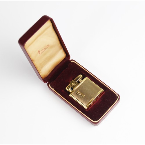 294 - A gold plated Ronson lighter, of rectangular form with engine turned decoration with cartouche engra... 