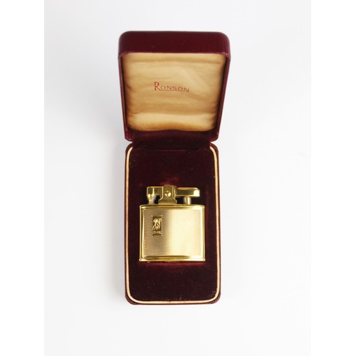 294 - A gold plated Ronson lighter, of rectangular form with engine turned decoration with cartouche engra... 